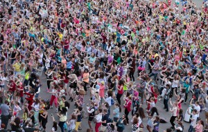 People perform a Gangnam style dance during a flash mob before the arrival of South Korean rapper Psy in Moscow