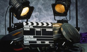 Clapperboard, film and two floodlights
